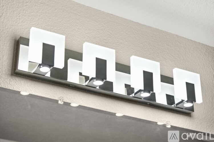 A wall-mounted light fixture with six square lights.