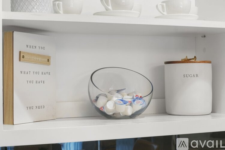 A book with the title "When you have what you hate you need sugar" is on a shelf next to a glass bowl filled with candy and a white sugar container.