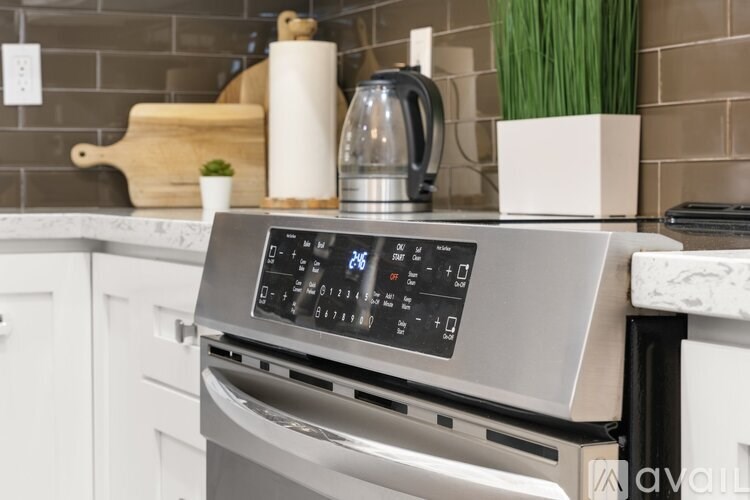 A modern stainless steel oven with a digital display on the front.