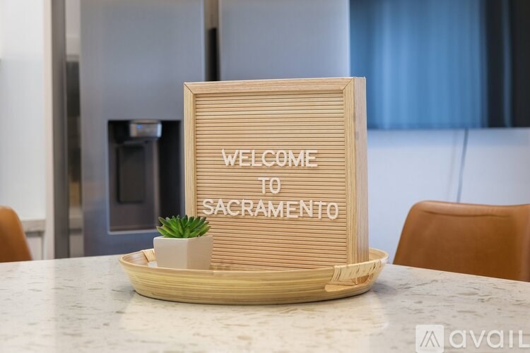 A wooden sign that says "Welcome to Sacramento" is on a table.