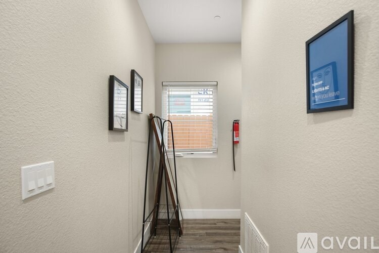 A hallway with a tripod leaning against the wall.