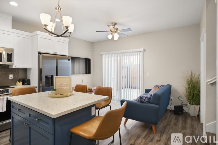 A kitchen with a dining table and chairs.