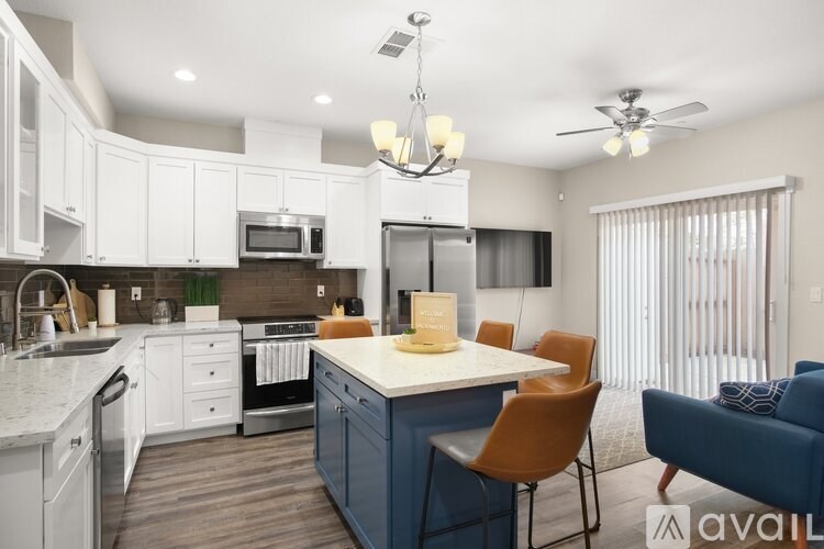 A kitchen with a dining table and chairs.
