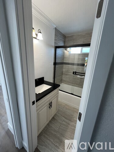 A bathroom with a sink and a mirror.