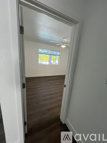 A white toilet sits next to a glass shower door in a bathroom.