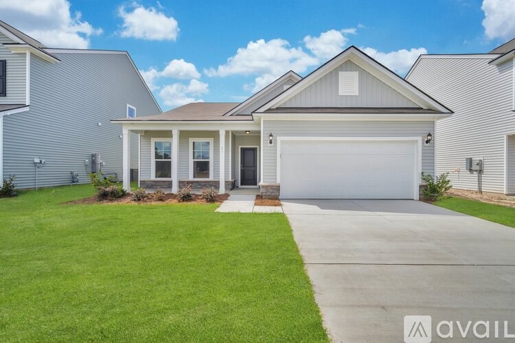 A house with a garage and a driveway in front of it.