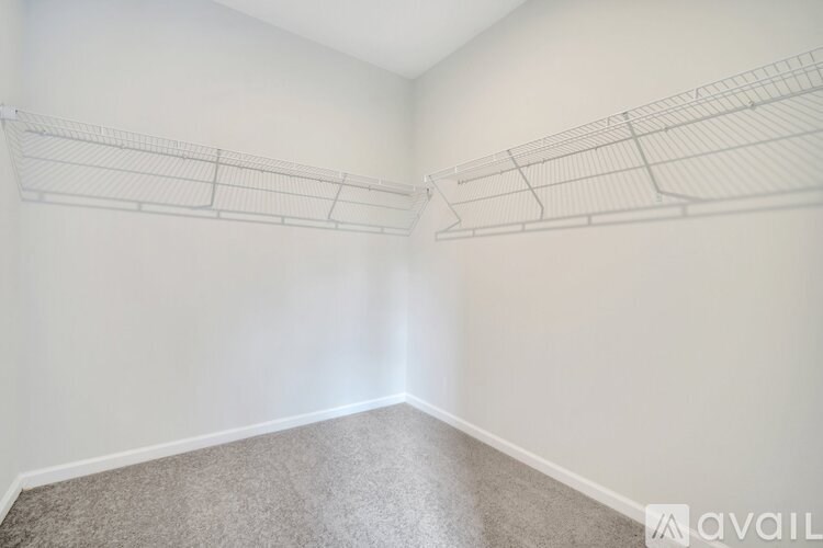 Empty room with white walls and carpeted floor.