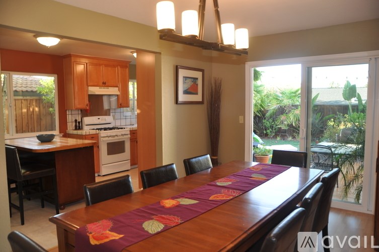 A kitchen with a table set for a meal.