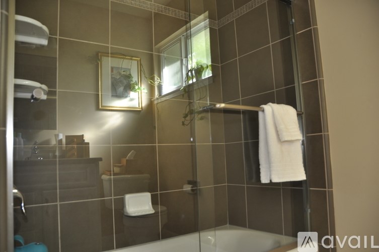 A bathroom with a white towel hanging on a rack.