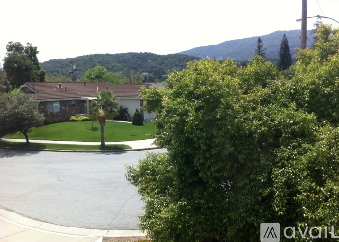 A house with a mountain in the background is for sale.