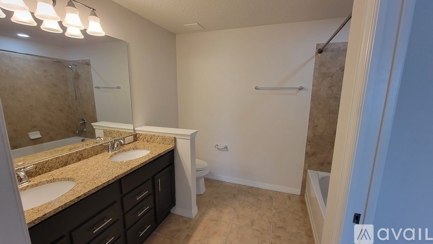 A bathroom with a sink, mirror, and toilet.
