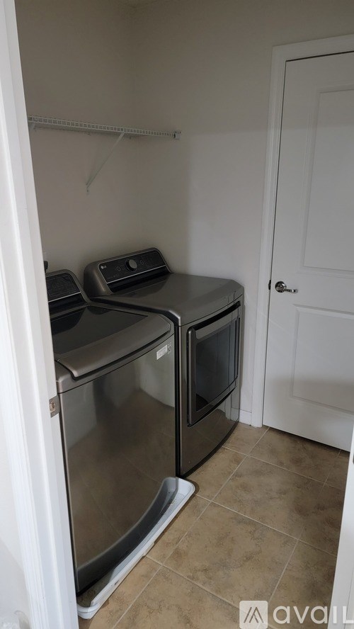 A small kitchen with two ovens and a door.