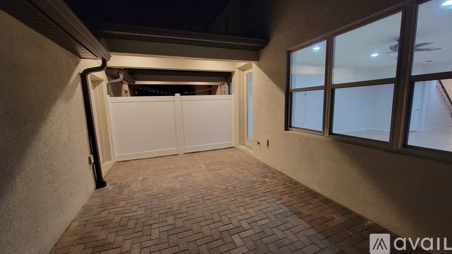 A room with a sliding door and brick flooring.