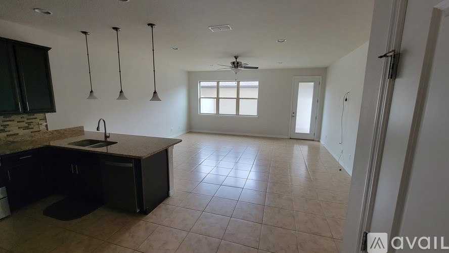 A kitchen with a sink and a window.