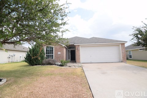 A house with a garage and a driveway is available for sale.