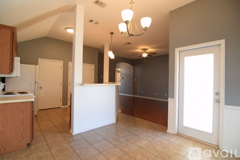A kitchen with a white counter and a refrigerator.