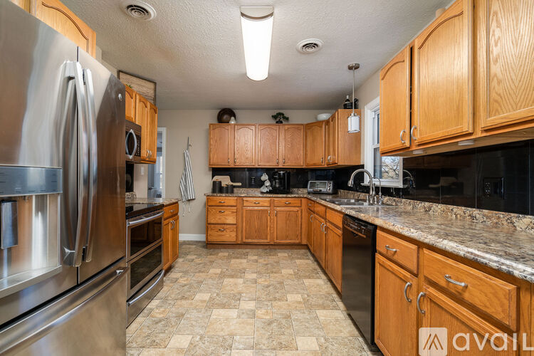 A kitchen with wooden cabinets and granite countertops.