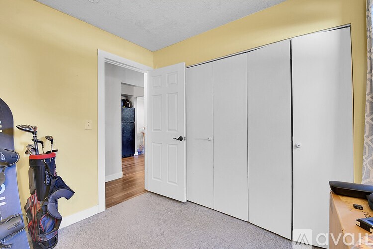 A room with a yellow wall and a white door.