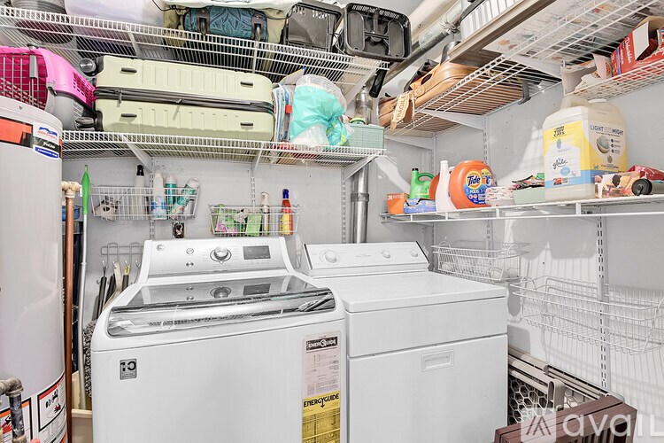 A white washing machine and dryer in a small laundry room.