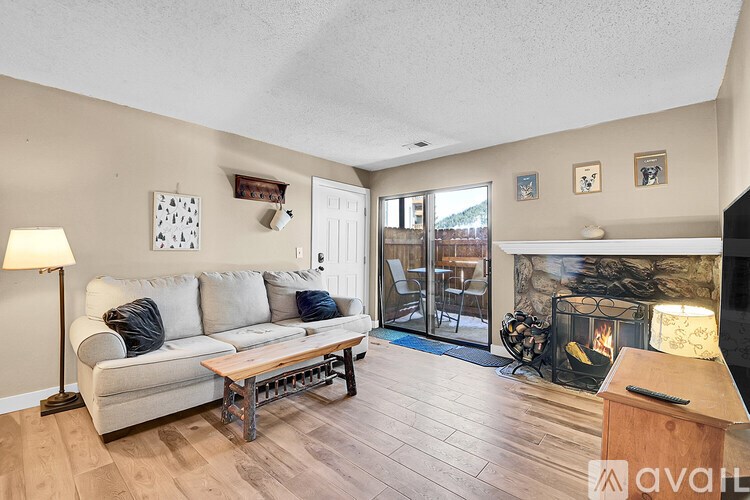 A living room with a couch, a fireplace, and a television.