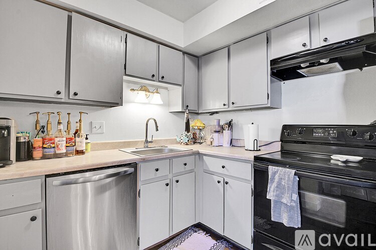 A kitchen with a black oven and a sink with a faucet.