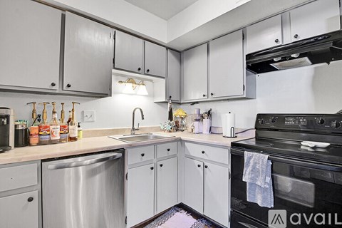 A kitchen with a black oven and a sink with a faucet.