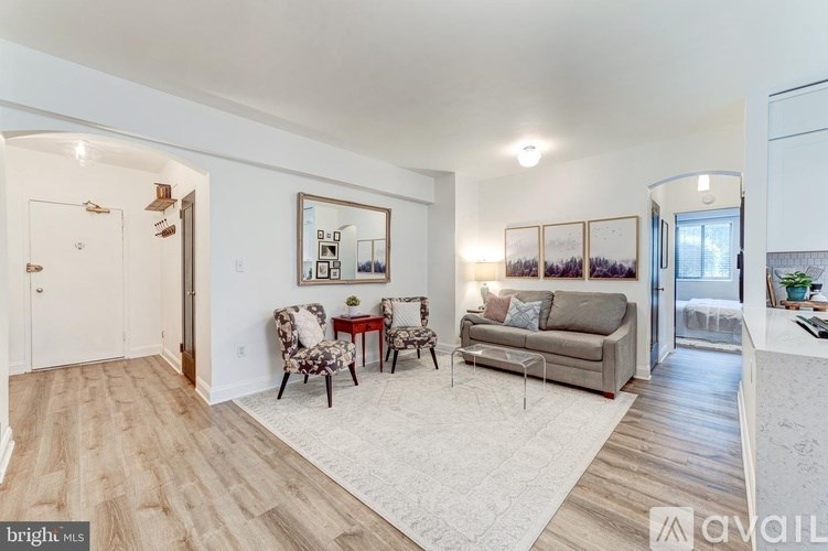 A living room with a couch, chair, and a coffee table.