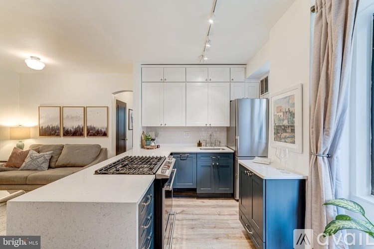 A modern kitchen with a white countertop and blue cabinets.