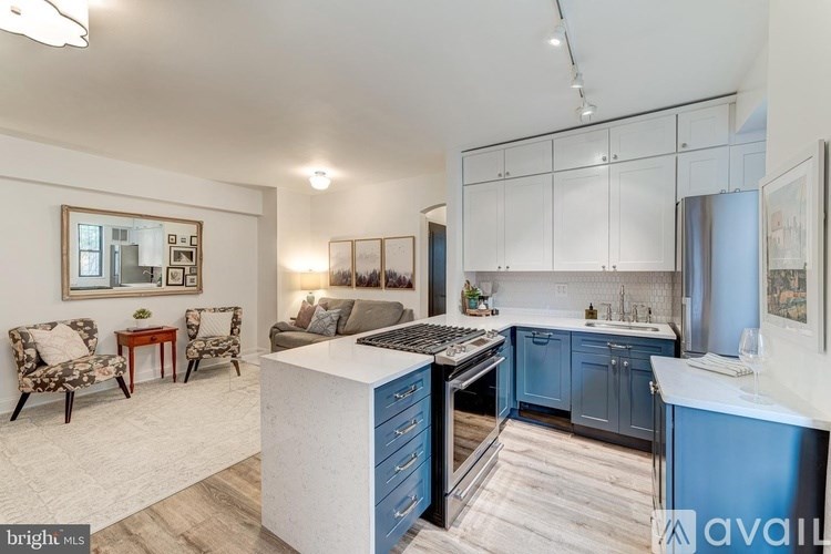 A kitchen with a white island and blue cabinets.