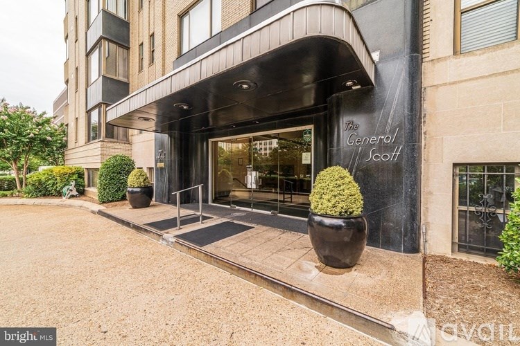 The General Scott building has a black awning and a sign on it.
