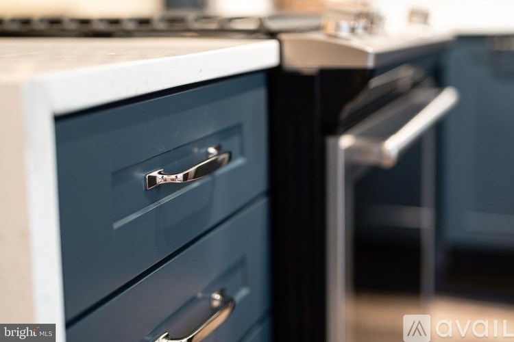 A close up of a kitchen with a white stove and a black oven.