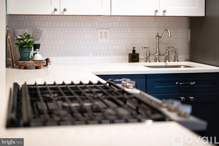 A modern kitchen with a black stove top oven.