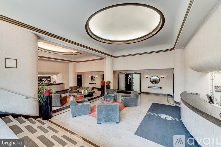 A spacious living room with a curved ceiling and a reception desk.