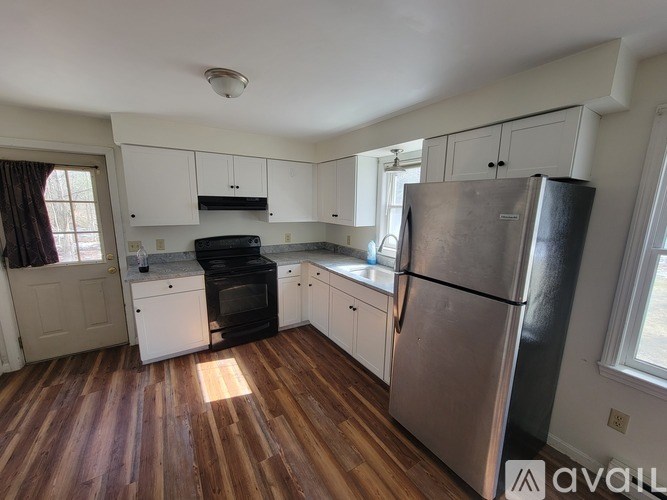 A kitchen with a black oven and a black fridge.