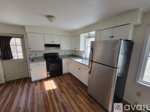 A kitchen with a black oven and a black fridge.