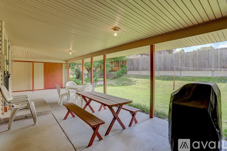 A patio with a table and chairs is shown.