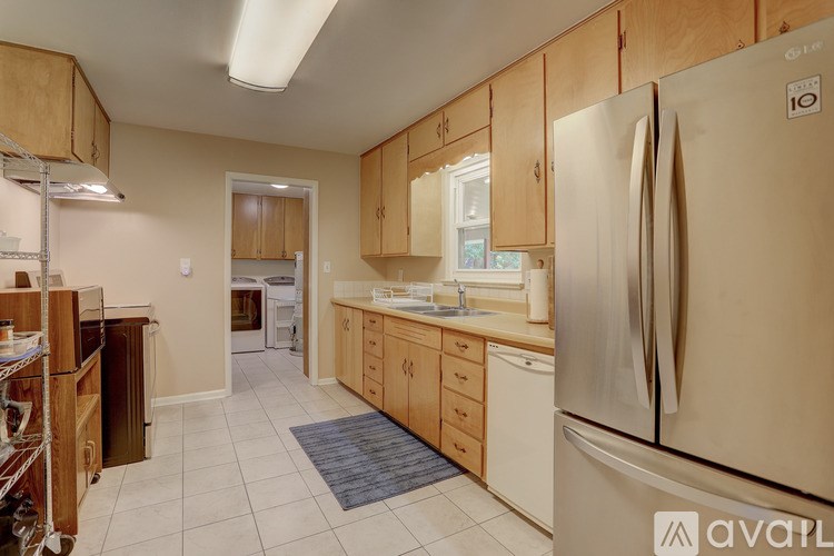 A kitchen with wooden cabinets and a refrigerator.