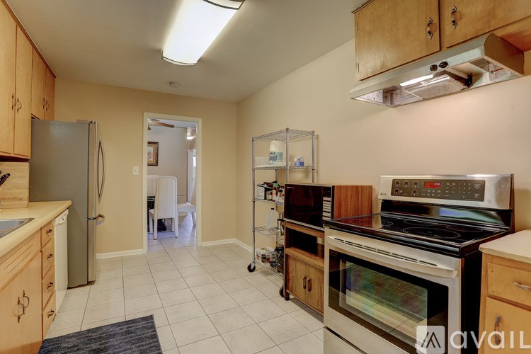 A kitchen with a refrigerator, oven, and microwave.