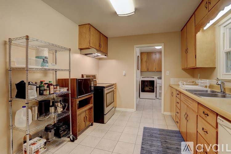A kitchen with a sink, stove, and oven.