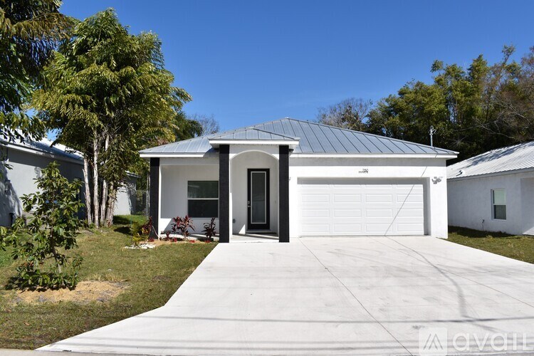 A modern house with a metal roof and a garage door.