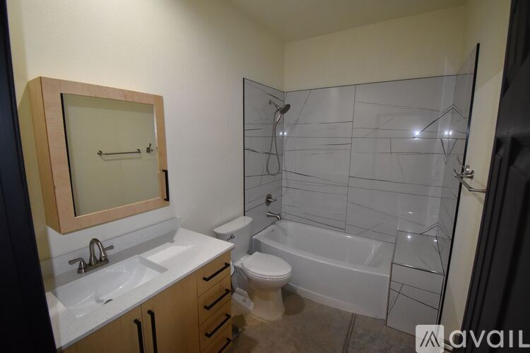 A bathroom with a toilet, sink, and bathtub.