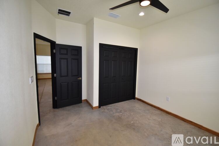 A room with two doors and a ceiling fan.