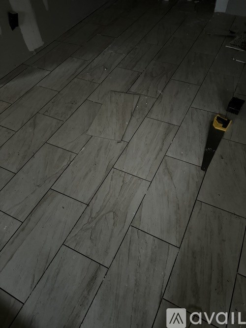 A tile floor with a black strap on it.