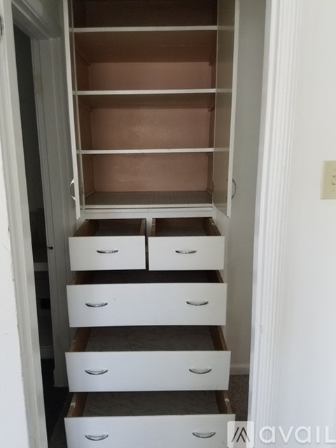 A white drawer cabinet with six drawers is open.