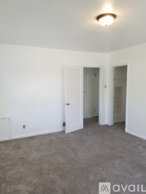 A room with carpeted floor and white walls.