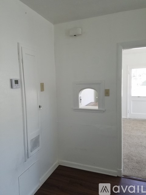 A white room with a window and a door.