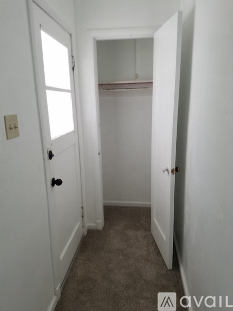 A white door with a black handle is open.