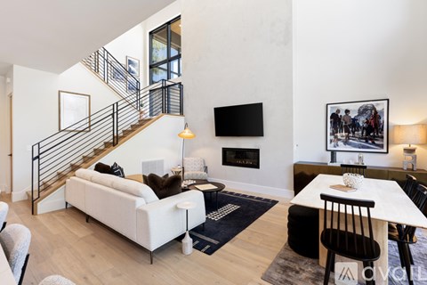 A living room with a white couch and a black chair.