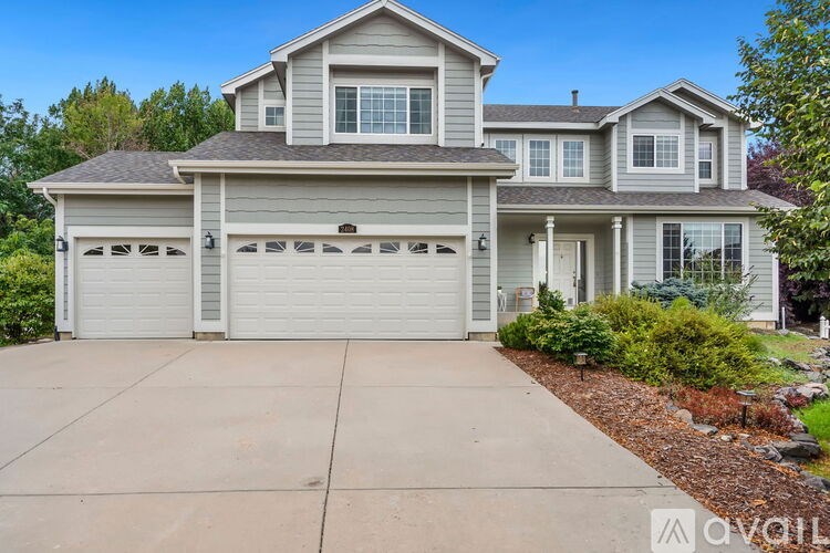 A two-story house with a garage is available for sale.
