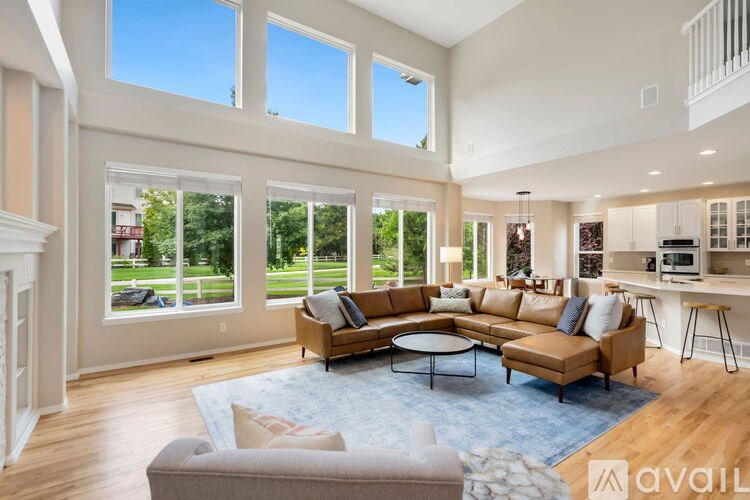 A spacious living room with a large sectional sofa and a coffee table in the center.